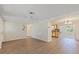 Inviting living room with wood flooring, ceiling fan, and an open view into the adjacent dining area and kitchen at 3728 Linkwood St, New Port Richey, FL 34652