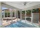 Enclosed sunroom with large sliding windows overlooking a gazebo and backyard at 3728 Linkwood St, New Port Richey, FL 34652