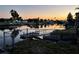 Backyard with canal view at sunset, offering serene water views, dock, and tranquil outdoor setting at 4046 Casa Ct, Hernando Beach, FL 34607