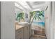 Updated bathroom featuring gray vanity, vessel sink, and tropical shower curtain at 4046 Casa Ct, Hernando Beach, FL 34607