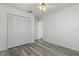 Bedroom featuring wood-look floors, ceiling fan, and spacious closet at 4046 Casa Ct, Hernando Beach, FL 34607