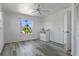 Light-filled bedroom with hardwood floors, ceiling fan, and an abundance of natural light at 4046 Casa Ct, Hernando Beach, FL 34607