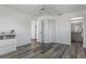 Spacious bedroom features neutral color palette, wood floors, and access to ensuite bathroom at 4046 Casa Ct, Hernando Beach, FL 34607