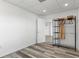 A room with modern gray toned wood laminate floors and a door leading to a closet area at 4046 Casa Ct, Hernando Beach, FL 34607