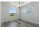 Bright bedroom featuring wood-look floors and lots of natural light at 4046 Casa Ct, Hernando Beach, FL 34607
