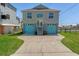 Two-story home featuring a two-car garage with blue doors and a well-maintained front yard at 4046 Casa Ct, Hernando Beach, FL 34607