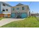 Charming two-story house with blue garage doors, stairs leading to the front door, and a well-kept lawn at 4046 Casa Ct, Hernando Beach, FL 34607