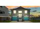 Two-story home featuring a two-car garage with blue doors, well-maintained front yard and a sunset at 4046 Casa Ct, Hernando Beach, FL 34607