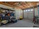 Spacious garage featuring exposed wood ceilings, lighting, storage shelves and parking space at 4046 Casa Ct, Hernando Beach, FL 34607