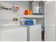 Laundry area featuring washer, dryer, and storage shelving at 4046 Casa Ct, Hernando Beach, FL 34607