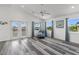 Living room with gray-tone floors, a ceiling fan, and ample natural light at 4046 Casa Ct, Hernando Beach, FL 34607