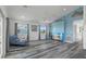Bright living room with vaulted ceiling, gray floors, and decorative accents, creating a welcoming atmosphere at 4046 Casa Ct, Hernando Beach, FL 34607