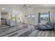 Bright open living room boasts vaulted ceilings, French doors, and stylish gray-toned flooring at 4046 Casa Ct, Hernando Beach, FL 34607