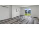 Living room featuring wood-look floors and sliding glass doors to waterfront at 4046 Casa Ct, Hernando Beach, FL 34607