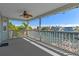 Covered porch with chairs, ceiling fan, string lights, and view of the bay at 4046 Casa Ct, Hernando Beach, FL 34607