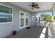 Covered porch with chairs, ceiling fan, string lights, and double doors to inside the home at 4046 Casa Ct, Hernando Beach, FL 34607