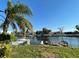 Waterfront property featuring a canal view with a boat lift, dock, and lush greenery at 4046 Casa Ct, Hernando Beach, FL 34607