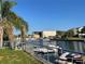 Waterfront property with canal access, boat lift, and views of boat storage building on a sunny day at 4046 Casa Ct, Hernando Beach, FL 34607