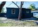 Home exterior with a view of the spacious backyard featuring a mature tree for shade at 4601 N 37Th St, Tampa, FL 33610