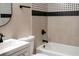 Well-lit bathroom featuring decorative tile, black fixtures, and clean white porcelain at 4601 N 37Th St, Tampa, FL 33610
