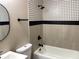 Updated bathroom showcasing clean tile, fresh fixtures, and a soaking tub at 4601 N 37Th St, Tampa, FL 33610