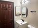 Bathroom featuring an updated sink, toilet, and bronze color door and accents at 4601 N 37Th St, Tampa, FL 33610