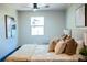 Bright bedroom featuring hardwood floors, a ceiling fan, and a sun-filled window at 4601 N 37Th St, Tampa, FL 33610