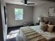 Bright bedroom featuring hardwood floors, a ceiling fan, and a sun-filled window at 4601 N 37Th St, Tampa, FL 33610