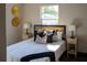 Well-lit bedroom featuring wood floors and two side tables with lamps at 4601 N 37Th St, Tampa, FL 33610