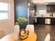Dining area showcasing a view to the kitchen with stainless steel appliances and dark cabinets at 4601 N 37Th St, Tampa, FL 33610