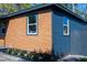 Charming home exterior featuring mixed siding, modern windows, and landscaped garden bed at 4601 N 37Th St, Tampa, FL 33610