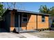 Charming house exterior featuring wood siding, gray accents, and a well-maintained lawn at 4601 N 37Th St, Tampa, FL 33610