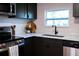 Modern kitchen with stainless appliances, black cabinets and sleek countertops at 4601 N 37Th St, Tampa, FL 33610