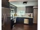 Modern kitchen boasting dark cabinets, stainless steel appliances, and hardwood floors at 4601 N 37Th St, Tampa, FL 33610