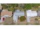 Aerial view displaying property with a gray roof, carports, and grassy yards in the neighborhood at 4743 Foothill Dr, Holiday, FL 34690