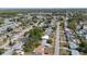 Aerial view of a residential neighborhood showcasing rooftops, streets, and mature trees at 4743 Foothill Dr, Holiday, FL 34690