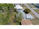 Aerial view of a single-Gathering home with a large backyard, carport, and mature trees at 4743 Foothill Dr, Holiday, FL 34690