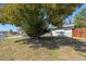 Home exterior with mature landscaping including a large shade tree at 4743 Foothill Dr, Holiday, FL 34690