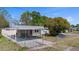 Charming single-story home featuring a covered carport and fenced front yard on a sunny day at 4743 Foothill Dr, Holiday, FL 34690