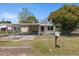 Charming home with a carport, fenced yard, and mailbox, offering a welcoming curb appeal at 4743 Foothill Dr, Holiday, FL 34690
