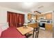 Open-concept kitchen and dining area featuring wood cabinets, tile flooring, and modern appliances at 4743 Foothill Dr, Holiday, FL 34690