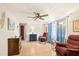 Cozy living room with tile flooring, blue curtains, comfortable seating and ceiling fan at 4743 Foothill Dr, Holiday, FL 34690