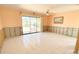 Living room featuring sliding glass doors to backyard, tile floors, ready to be remodeled at 4933 Southshore Dr, New Port Richey, FL 34652