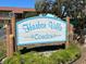 Harbor Villa Condos signage surrounded by lush green landscaping and showcasing community pride at 4937 Marine Pkwy # 201, New Port Richey, FL 34652