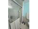 Modern bathroom featuring shower stall with glass doors, a toilet, tiled walls and towel at 5211 Wisteria Cir, New Port Richey, FL 34653