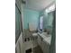 Well-lit bathroom with a shower stall, a toilet, vanity, and tiled floor with a white towel at 5211 Wisteria Cir, New Port Richey, FL 34653