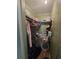 Walk-in closet providing ample storage space with rod, shelving and a chair at 5211 Wisteria Cir, New Port Richey, FL 34653
