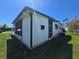 Exterior side view of a home featuring a screened in porch and air conditioning unit at 5211 Wisteria Cir, New Port Richey, FL 34653