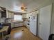 Bright kitchen featuring white cabinets, modern appliances and vinyl flooring at 5211 Wisteria Cir, New Port Richey, FL 34653