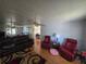 Living room with hardwood floors, ceiling fan, sofa, and chairs at 5211 Wisteria Cir, New Port Richey, FL 34653
